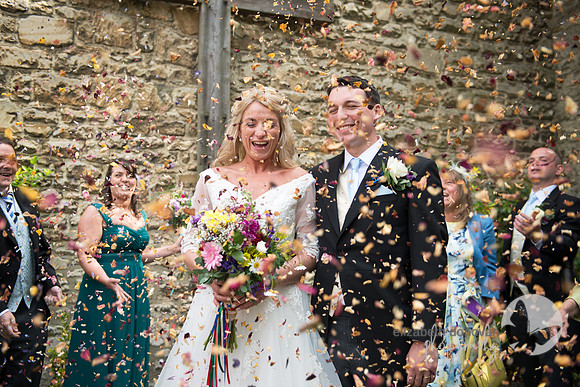 elizabeth donovan photography  bride and groom covered in pretty  confetti wiltshire