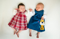 cousin babies hold hands in cute photograph Baby photo shoot in the home natural photography with little one family lifestyle swindon wiltshire