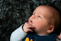 cute little boy on soft grey blanket Baby photo shoot in the home natural photography with little one family lifestyle swindon wiltshire