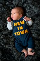 new to town baby in cute babygro Baby photo shoot in the home natural photography with little one family lifestyle swindon wiltshire