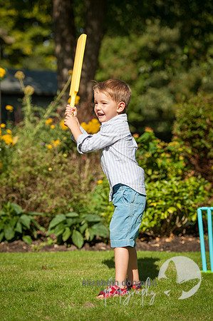 summer photo shoot in family garden in wiltshire boy playing cricket elizabeth donovan photography