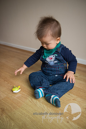 cute sitting up boy playing with his toys Baby photo shoot in the home natural photography with little one family lifestyle swindon wiltshire