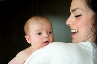 mother smiling at baby boy Baby photo shoot in the home natural photography with little one family lifestyle swindon wiltshire