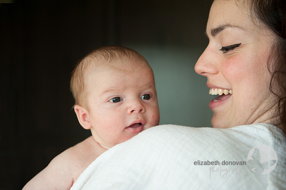 mother smiling at baby boy Baby photo shoot in the home natural photography with little one family lifestyle swindon wiltshire