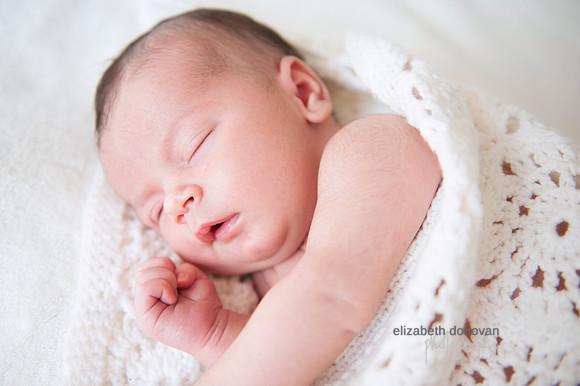 newborn baby wrapped in family blanket Baby photo shoot in the home natural photography with little one family lifestyle swindon wiltshire