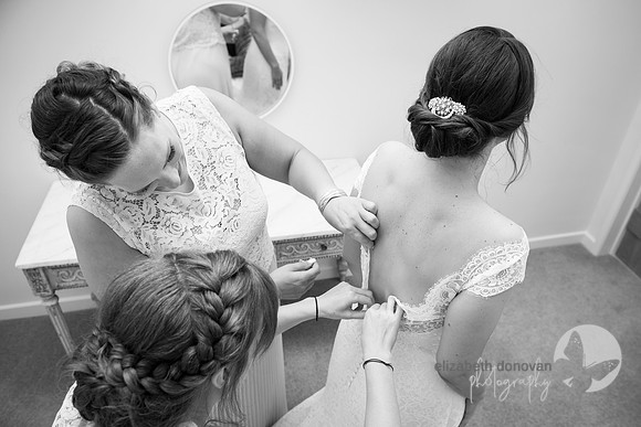 getting the brides buttons done up elizabeth donovan photography  wiltshire