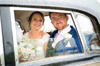 bride and groom in their vintage car on a rainy day elizabeth donovan photography