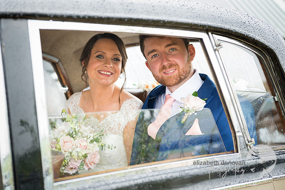 bride and groom in their vintage car on a rainy day elizabeth donovan photography
