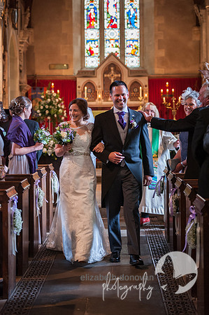 elizabeth donovan photography  bride and groom walking out of broad hinton church