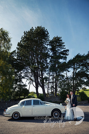 bride and groom stand by their vintage wedding car elizabeth donovan photography