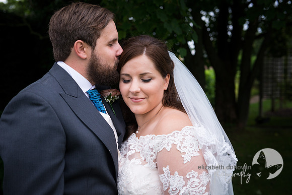 groom kissing the bride on the forehead elizabeth donovan photography