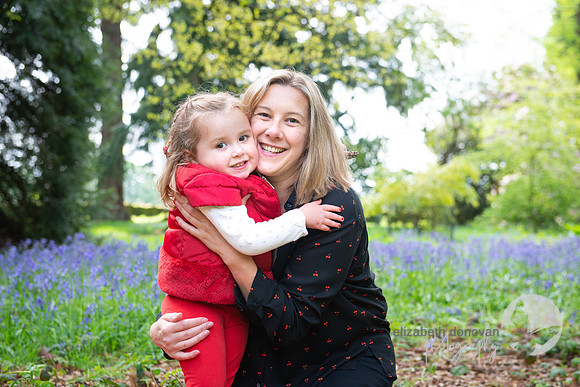 beautiful photograph of mother and sweet outdoors relaxed photo shoot in the spring bluebells