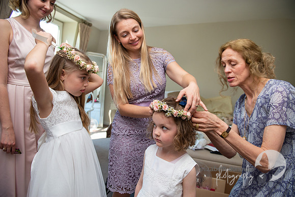 Mother of the bride helps little cute bridesmaid with her flowers elizabeth donovan photography