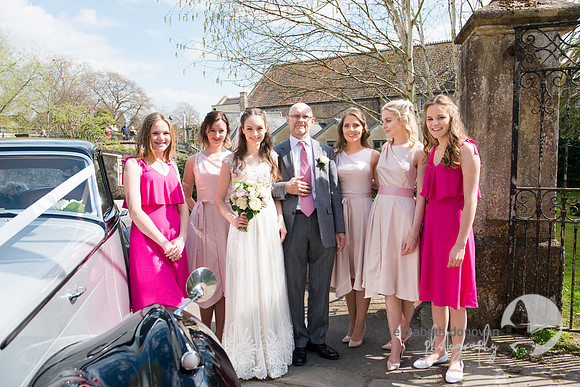 bride with her dad and bridesmaids wearing pink elizabeth donovan photography