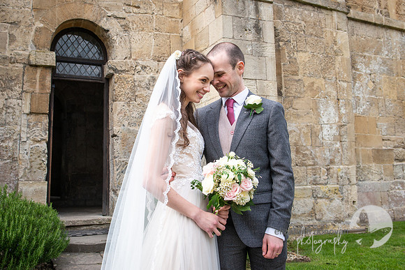 bride and groom share a moment outside church elizabeth donovan photography  wiltshire