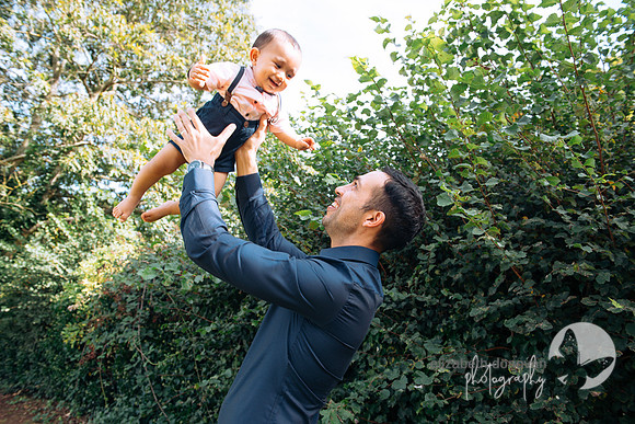 little baby boy playing with dad flying in the air beautiful childrens portait relaxed outdoor family portrait in swindon elizabeth donovan photography cute children portrait