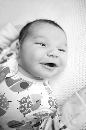 smiling 2 week old baby girl Baby photo shoot in the home natural photography with little one family lifestyle swindon wiltshire