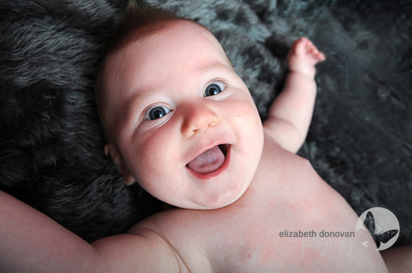 baby boy very happy and looking at the camera Baby photo shoot in the home natural photography with little one family lifestyle swindon wiltshire