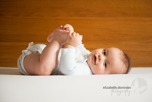 baby catching his toes Baby photo shoot in the home natural photography with little one family lifestyle swindon wiltshire