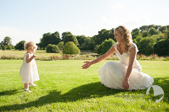 bride and her cute daughter flower girl in a green field stanton house hotel elizabeth donovan photography